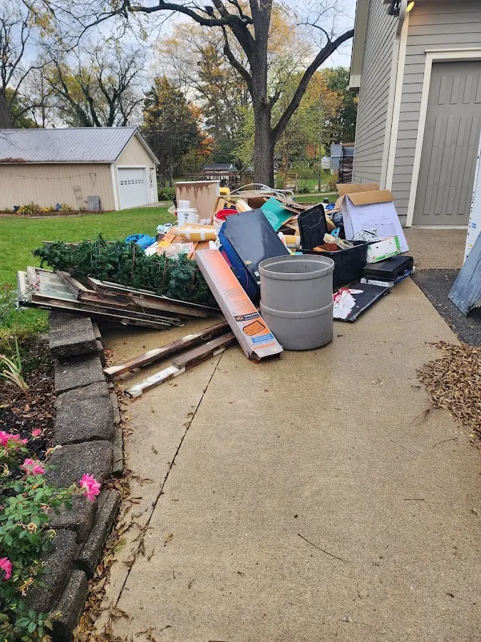 Dumpster being loaded with debris for Estate Cleanout Dumpster Rental in Dobbs Ferry